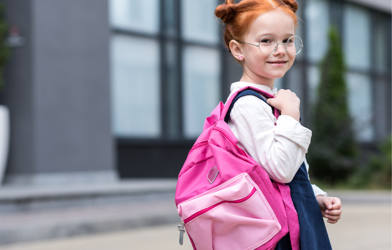 Cute kid with glasses on heading to school
