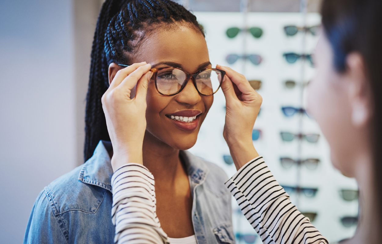 A lady trying out glasses in an optical store