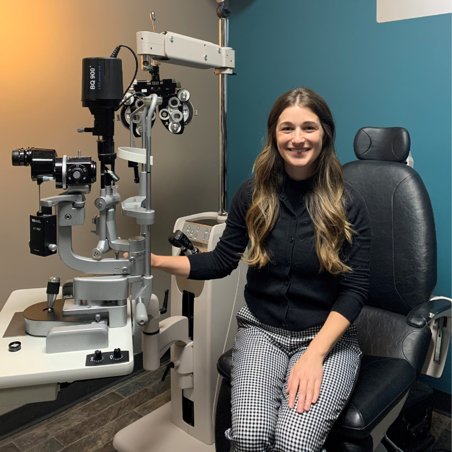 An Optometrist sitting beside an eye machine